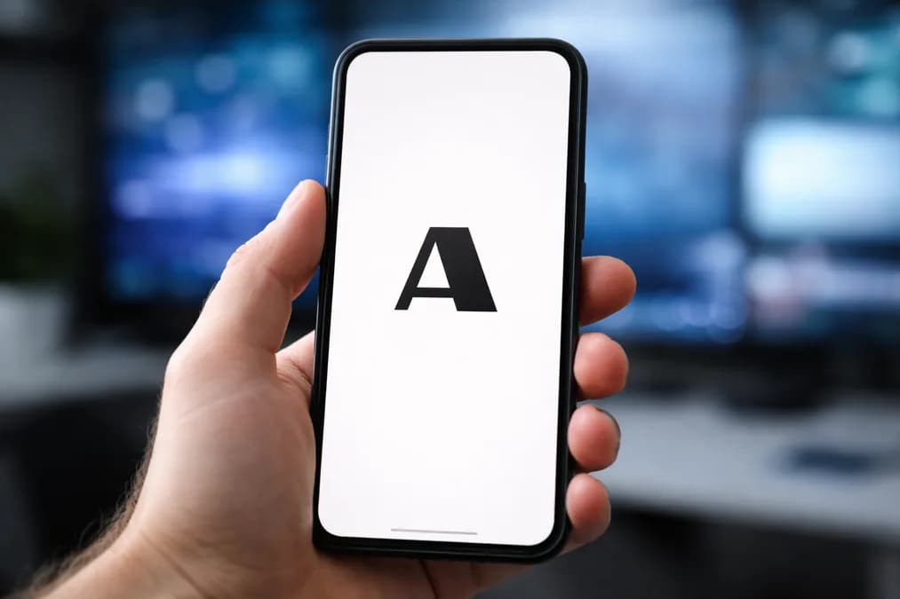 Anthropic logo on phone: Anthropic Tolak Larangan Model AI Terbuka, Fokus ke Kendali Chip