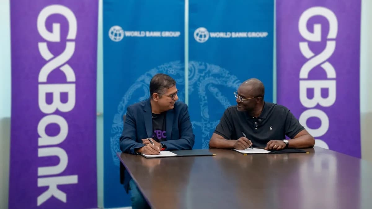 Two men signing documents: GXBank dan IFC Gelontorkan $110 Juta untuk UMKM Malaysia — Tapi Apa yang Hilang dari Skema Ini?